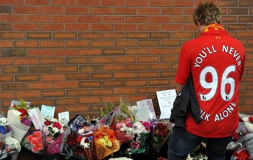 A supporter pays his respects outside Anfield to the 96 supporters who died in the 1989 Hillsborough disaster