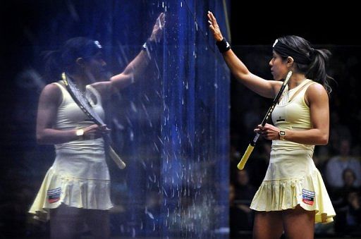 Nicol David is reflected in the glass during the Australian Open in Canberra, August 19, 2012