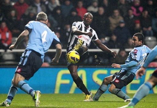 Newcastle&#039;s striker Shola Ameobi (2nd L) scores in Newcastle, England on December 22, 2012