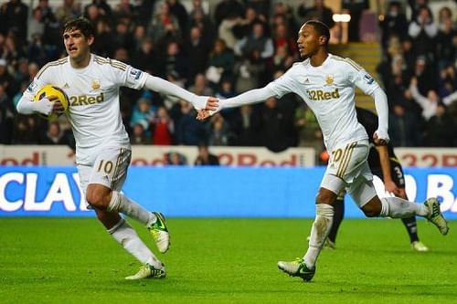 Swansea City midfielder Jonathan de Guzman (R) and Danny Graham at a Premier League match on December 8, 2012 Swansea City midfielder Jonathan de Guzman (R) and Danny Graham at a Premier League match on December 8, 2012