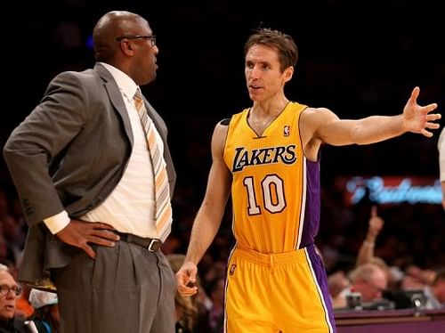 Los Angeles Lakers' Steve Nash confers with former coach Mike Brown during a game at Staples Center on October 30, 2012