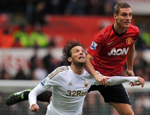 Manchester United&#039;s Nemanja Vidic vies with Swansea&#039;s Miguel Michu (left) Swansea, South Wales,  December 23, 2012