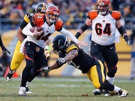 Andy Dalton of the Bengals tries to get around the tackle of James Harrison of the Steelers on December 23, 2012