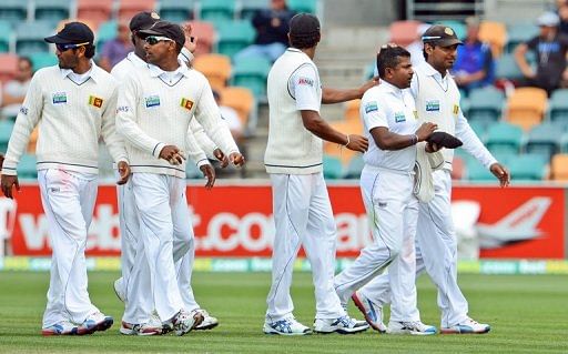 Sri Lankan bowler Rangana Herath (2nd R) is congratulated by teammates, in Hobart, on December 17, 2012