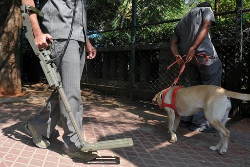 Indian bomb squad officials carry out a routine check outside the Chinnaswamy stadium in Bangalore on December 24, 2012