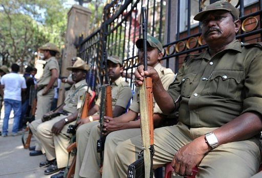 Armed Indian police on guard at the main gate of the M. Chinnaswamy Stadium in Bangalore on December 25, 2012