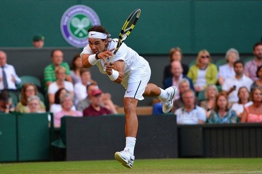 Spain&#039;s Rafael Nadal plays a shot against Czech Republic&#039;s Lukas Rosol at Wimbledon on June 28, 2012