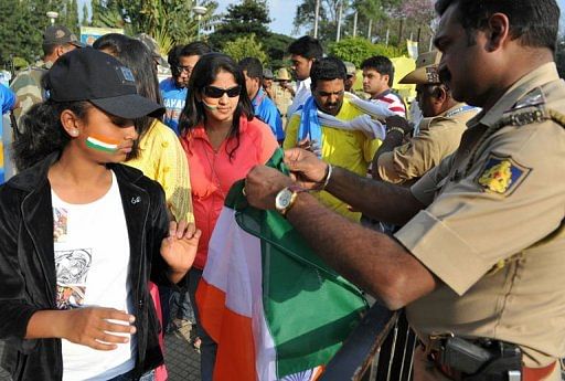 Cricket fans undergo security checks in Bangalore on December 25, 2012