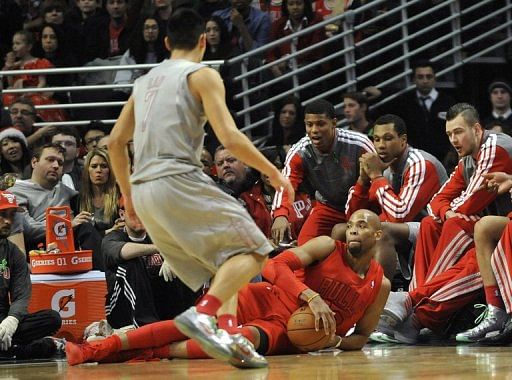 Taj Gibson of the Chicago Bulls grabs a loose ball in front of Jeremy Lin of the Houston Rockets on December 25, 2012