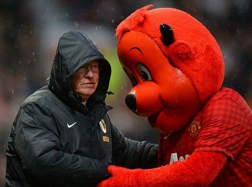 Manchester United manager Alex Ferguson shakes hands with Fred the Red at Old Trafford on December 26, 2012