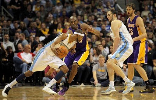 Corey Brewer of the Denver Nuggets slips past Kobe Bryant of the Los Angeles Lakers at Pepsi Center on December 26, 2012