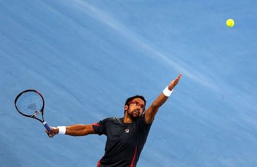 Serbia's Janko Tipsarevic serves to Britain's Andy Murray in the Emirati capital Abu Dhabi on December 27, 2012