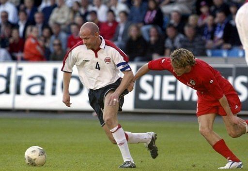 Henning Berg (L) pictured during his playing days in a friendly against Wales in Oslo on May 27, 2004