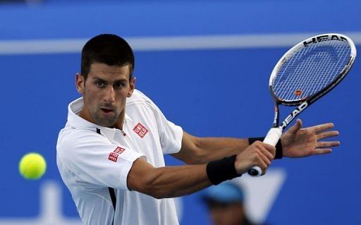 Novak Djokovic returns the ball to Spain&#039;s David Ferrer in Abu Dhabi on December 28, 2012.