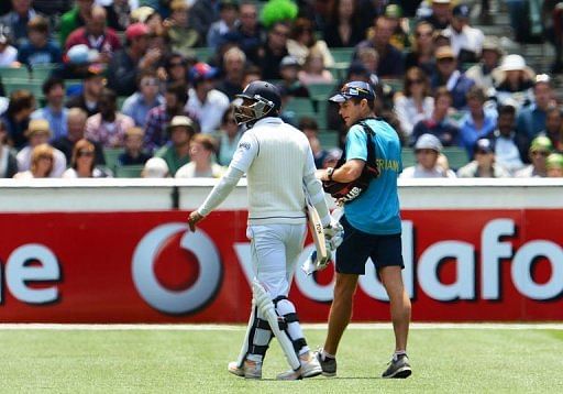 Sri Lanka batsman Kumar Sangakkara (L) walks off after having his hand injured at the MCG on December 28, 2012