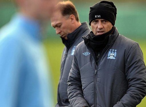 Manchester City manager Roberto Mancini (R) with his assistant David Platt in Manchester on December 3, 2012