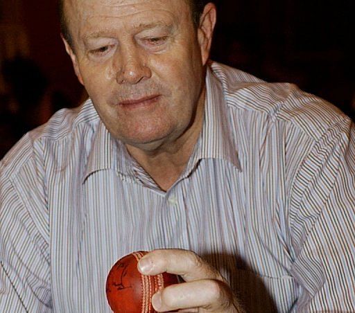 Ex-England cricket captain Tony Greig examines a ball at a memorabilia auction in Bangalore, on September 12, 2003