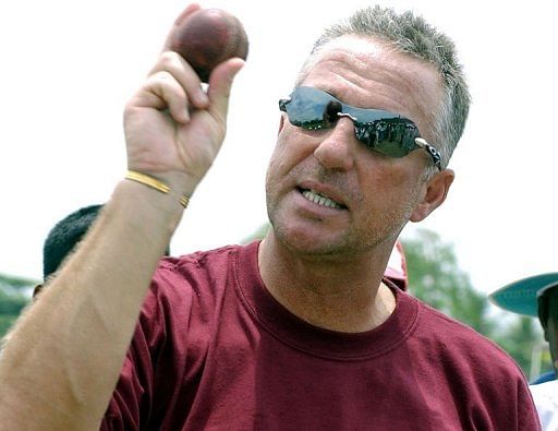 Former England cricket captain Ian Botham coaches Sri Lankan schoolboys during a visit to Galle on April 20, 2005