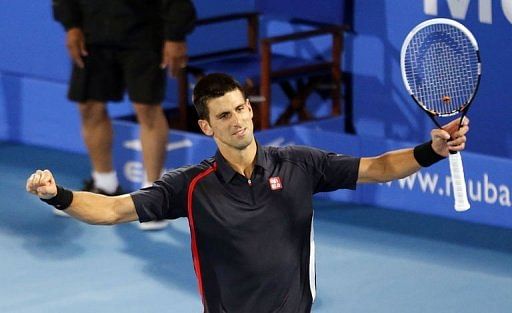 Novak Djokovic celebrates winning the Mubadala World Tennis Championship final in Abu Dhabi on December 29, 2012