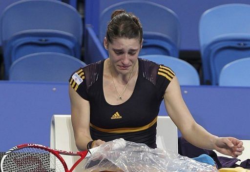 Andrea Petkovic receives treatment to her right knee during a Hopman Cup match in Perth on December 29, 2012