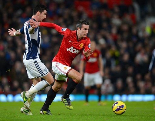 Manchester United&#039;s Robin van Persie slips past West Bromwich&#039;s  Liam Ridgewell at Old Trafford, December 29, 2012
