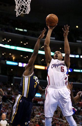 Caron Butler (R) of the Los Angeles Clippers shoots over DeMarre Carroll of the Utah Jazz, on December 30, 2012