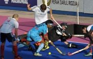 Britain's goalkeeper James Fair (C) dive