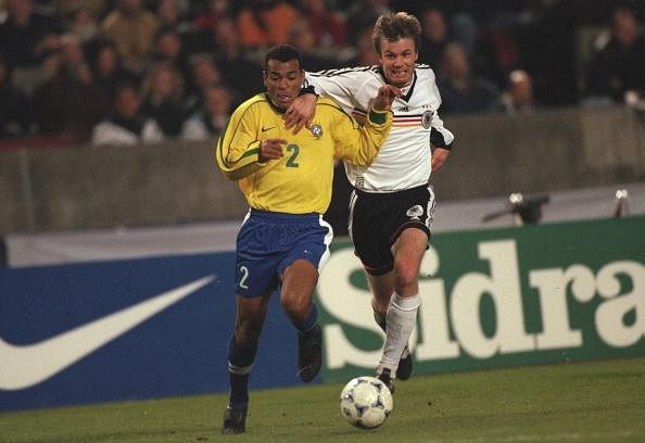 Cafu of Brazil fights off Thomas Helmer of Germany