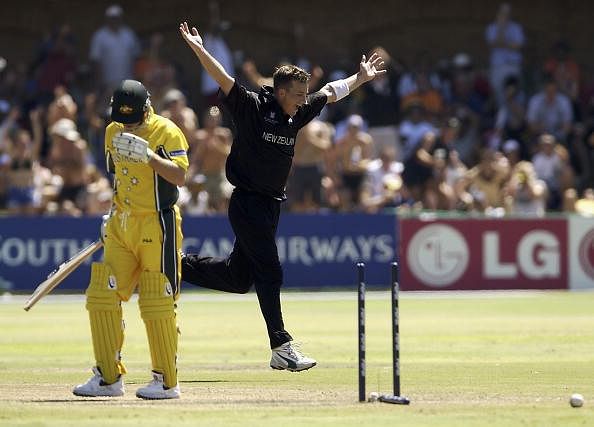 Shane Bond of New Zealand celebrates taking the wicket of Ian Harvey of Australia to finish with figures of 6 for 23