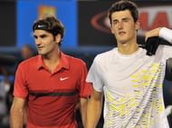 Roger Federer of Switzerland (L) walks o