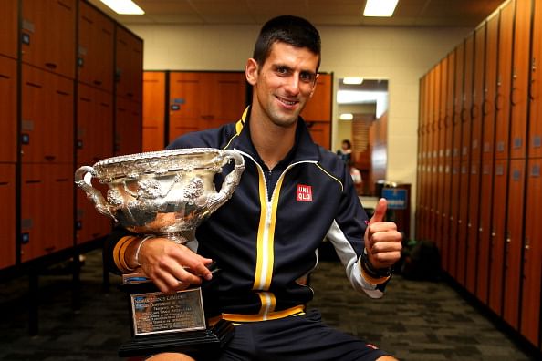 MELBOURNE, AUSTRALIA - JANUARY 28: (Editors Note. Image is a retransmission with an alternative crop.)  Novak Djokovic of Serbia poses with the Norman Brookes Challenge Cup in the changerooms after winning his men&#039;s final match 
