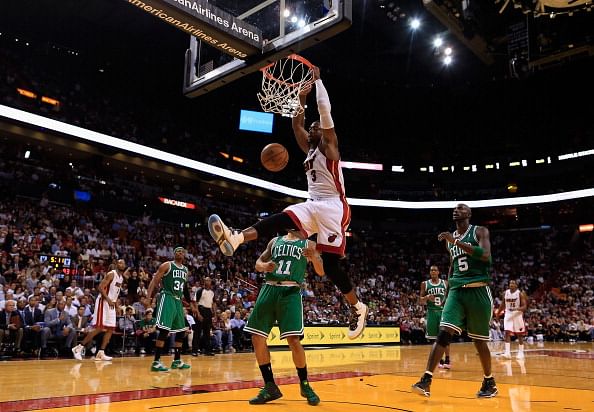 Dwyane Wade #3 of the Miami Heat dunks the ball over Courtney Lee #11 of the Boston Celtics