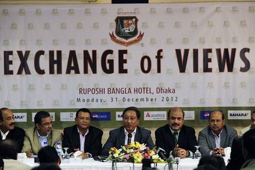 Bangladesh Cricket board President Nazmul Hasan (centre) addresses journalists in Dhaka on December 31, 2012