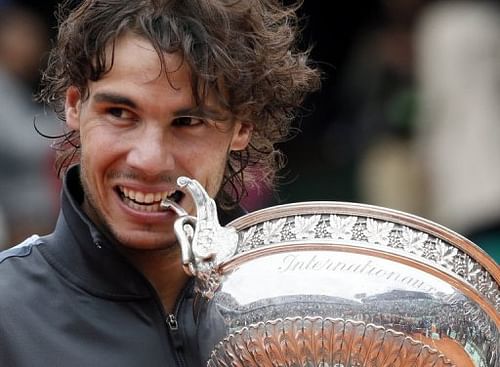 Rafael Nadal celebrates with his trophy after winning the French Open at the Roland Garros stadium, on June 11, 2012