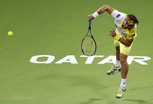 David Ferrer returns the ball to Dustin Brown during the 2013 ATP Qatar Open in Doha on January 1, 2013