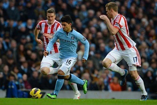 Sergio Aguero (C) gets away from Stoke defenders Robert Huth (L) and Ryan Shawcross on January 1, 2013