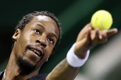 Gael Monfils serves to Philipp Kohlschreiber during the 2013 ATP Qatar Open in Doha on January 2, 2013