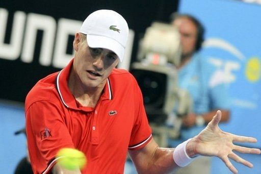 John Isner hits a return against Jo-Wilfried Tsonga during their Hopman Cup match in Perth, on January 1, 2013