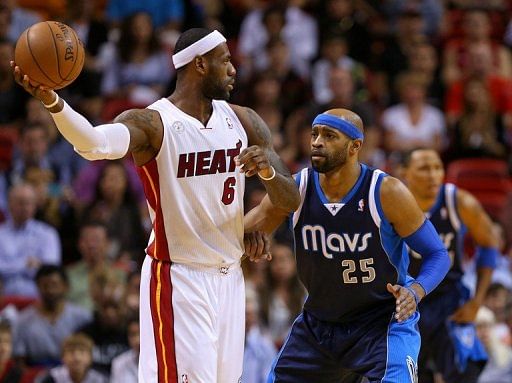 LeBron James of the Miami Heat fends off Vince Carter of the Dallas Mavericks on January 2, 2013