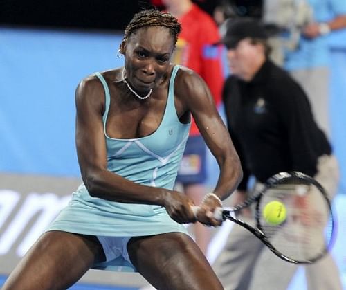 Venus Williams hits a return against Mathilde Johansson in their Hopman Cup clash in Perth on January 1, 2013