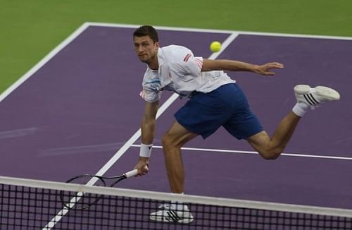 Germany's Daniel Brands hits a return to France's Gael Monfils on January 3, 2013 in Doha