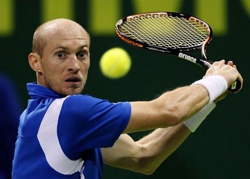 Russia&#039;s Nikolay Davydenko returns the ball to Italy&#039;s Simone Bolelli in Doha on January 3, 2013