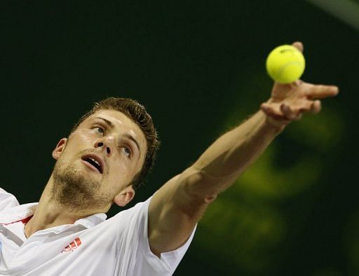Daniel Brands serves during the semi-finals at the Qatar Open in Doha on January 4, 2013