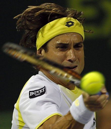 Spain&#039;s David Ferrer returns the ball to Russia&#039;s Nikolay Davydenko in Doha on January 4, 2013