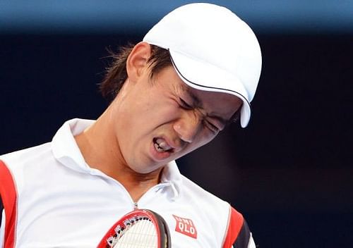 Kei Nishikori winces before retiring injured from his semi-final match against Andy Murray on January 5, 2013