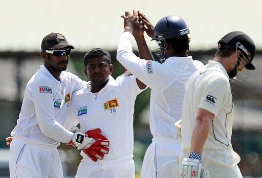 Sri Lankan cricketer Rangana Herath (second left) and teammates, Colombo, November 26 2012