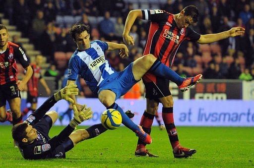 Wigan&#039;s Mauro Boselli (C) clashes with Bournemouth&#039;s Tommy Elphick (R) and Shwan Jalal in Wigan on January 5, 2013