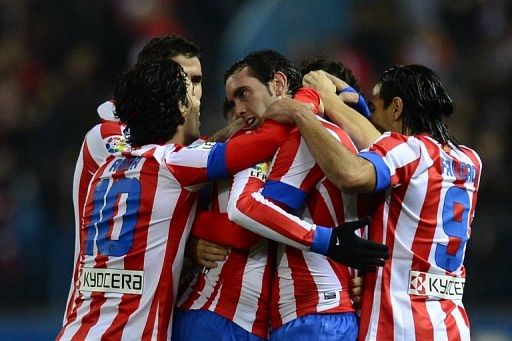 Atletico Madrid players celebrate after scoring a goal against Celta de Vigo, in Madrid, on December 21, 2012