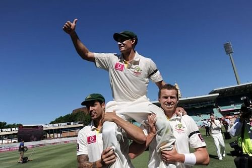 Peter Siddle (R) and Mitchell Johnson carry Australian teammate Mike Hussey off the field on January 6, 2013
