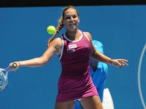 Dominika Cibulkova plays a forehand return during her first-round match against Petra Kvitova on January 6, 2013